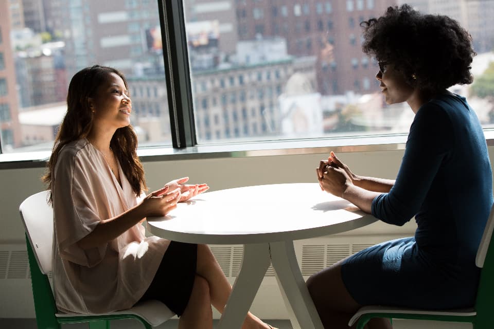 Two colleagues reviewing printed charts and reports at a table.